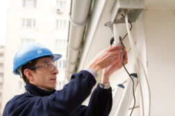 Man installing a security system