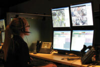 Security personnel looking at monitors