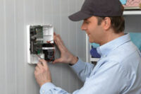 Man installing alarm system