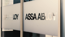 Image of ASSA ABLOY written on frosted glass.