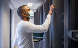 Man Wearing Mask Working on Security Server