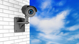 Video Camera Security System over Brick Wall with a sky background