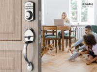 image of electronic lock in foreground with family sitting inside the home in the background