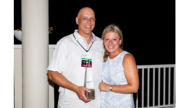 Image of Sascha Kylau holding the Stanley C. Lott Memorial Award.